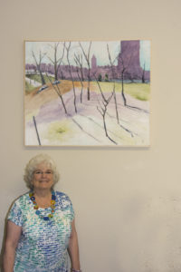 1 Ricki standing by her painting at the Vyt